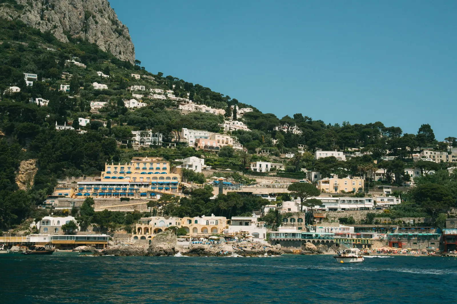 Capri hillside rising above bright blue Mediterranean water