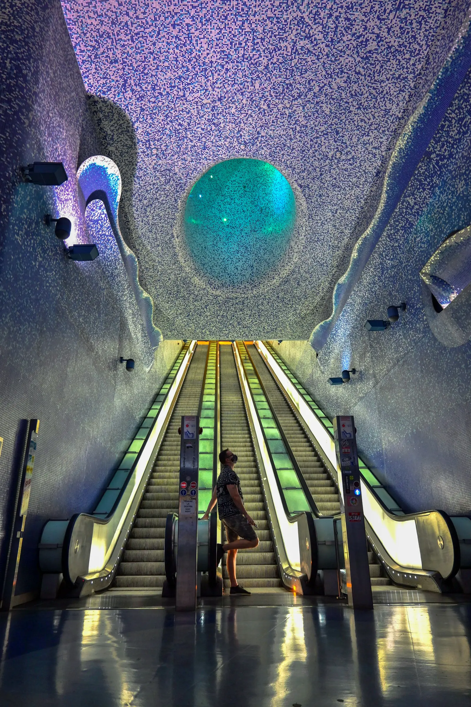 Travellers at an escalator inside Toledo metro station in Naples