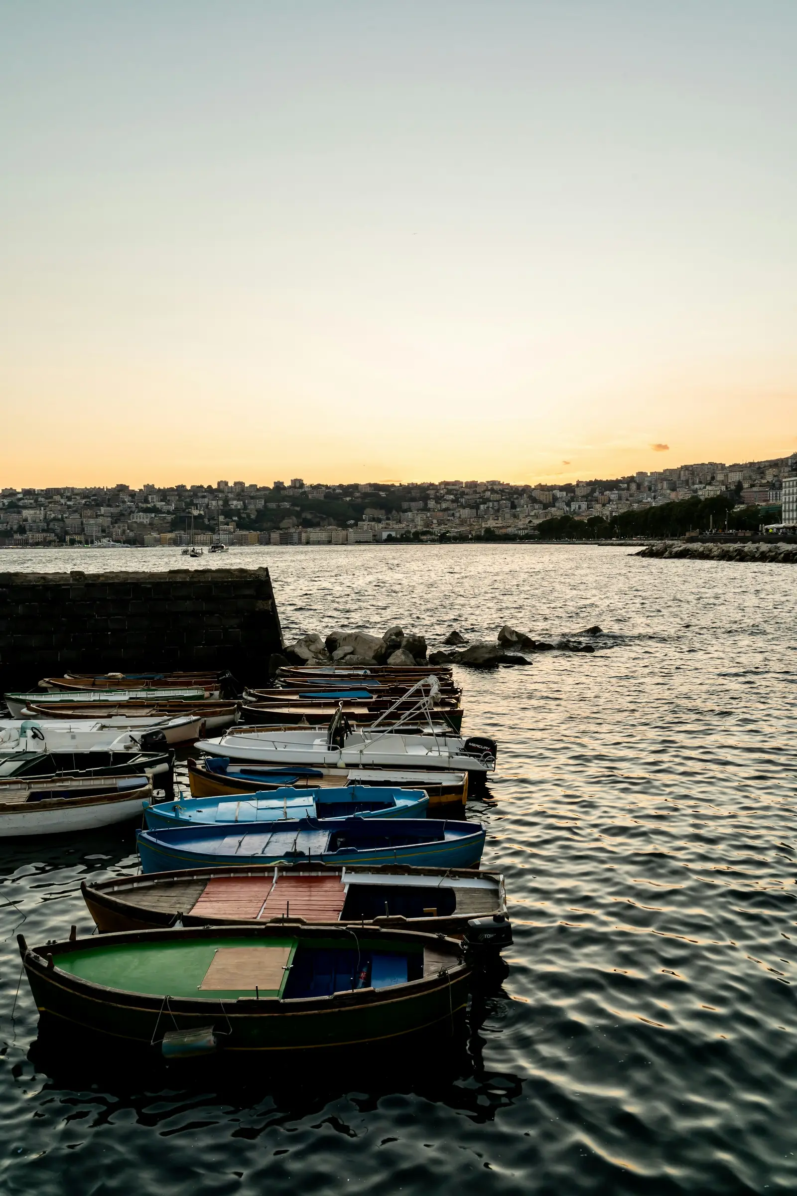 Boats on the Naples waterfront during golden hour